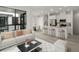 Open-concept living area with bar stools, a dining table, and large windows at 2046 S Holly St # 1, Denver, CO 80222