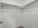 Walk-in closet with corner shelving and hanging rods at 2046 S Holly St # 1, Denver, CO 80222