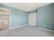 Carpeted bedroom with a closet and a view to another room at 10711 Longs Way, Parker, CO 80138