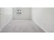 Bright bedroom with neutral carpet and a window providing natural light at 10711 Longs Way, Parker, CO 80138
