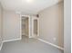 Neutral-toned bedroom showcasing doors to a closet and hallway at 10711 Longs Way, Parker, CO 80138