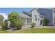 Charming home featuring unique shingle siding and a cozy covered porch surrounded by lush greenery at 10711 Longs Way, Parker, CO 80138