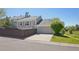 Beautiful gray home features a spacious two-car garage and a well-manicured lawn at 10711 Longs Way, Parker, CO 80138