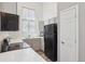 Bright kitchen with white cabinets and black appliances at 10711 Longs Way, Parker, CO 80138