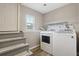 Laundry room includes washer, dryer, and a window providing natural light at 10711 Longs Way, Parker, CO 80138