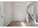 Open living area with wood floors and a staircase at 10711 Longs Way, Parker, CO 80138