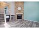 Spacious living room featuring a stone fireplace, hardwood floors, and plenty of natural light at 10711 Longs Way, Parker, CO 80138