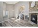 Bright living room with vaulted ceilings, stone fireplace, and wood floors at 10711 Longs Way, Parker, CO 80138