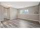 Living room with modern gray wood flooring and natural light from a large window at 10711 Longs Way, Parker, CO 80138