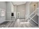 Spacious living room with high ceilings, hardwood floors, staircase, and door to outside porch at 10711 Longs Way, Parker, CO 80138