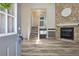 Open-concept living room featuring stone fireplace, hardwood floors, and staircase at 10711 Longs Way, Parker, CO 80138
