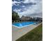 Community pool with lounge chairs and a view of the buildings under a cloudy sky at 10711 Longs Way, Parker, CO 80138