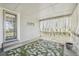 Covered porch with a green rug, sheer white curtains and access door at 10711 Longs Way, Parker, CO 80138