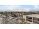 This aerial view shows the surrounding neighborhood with mountain views on the horizon at 2374 S University Blvd # 402, Denver, CO 80210