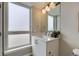Bright bathroom featuring a quartz countertop, undermount sink, and modern fixtures at 2374 S University Blvd # 402, Denver, CO 80210