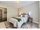 Cozy bedroom featuring a comfortable bed, accent rug, and natural light at 2374 S University Blvd # 402, Denver, CO 80210
