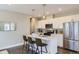 Modern kitchen featuring an island with seating, stainless appliances, and contemporary finishes at 2374 S University Blvd # 402, Denver, CO 80210