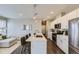 Bright kitchen with island seating, contemporary cabinets, and stainless steel appliances at 2374 S University Blvd # 402, Denver, CO 80210