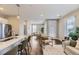 Open living area featuring hardwood floors, large windows, and a dining area in the background at 2374 S University Blvd # 402, Denver, CO 80210