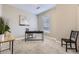 Office featuring neutral paint, a black desk and chair, and a large window at 2374 S University Blvd # 402, Denver, CO 80210