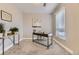 Office featuring neutral paint, a black desk and chair, and a large window at 2374 S University Blvd # 402, Denver, CO 80210