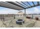 A modern rooftop patio featuring a fire pit and seating is perfect for outdoor relaxation and entertainment at 2374 S University Blvd # 402, Denver, CO 80210