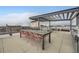 The rooftop patio boasts a grill, table and seating for ten, offering an outdoor living space at 2374 S University Blvd # 402, Denver, CO 80210