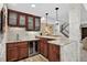 Basement bar with custom cabinetry, stone accents, and a wine refrigerator at 31189 Manitoba Dr, Evergreen, CO 80439