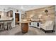 Finished basement with rustic barrel table, accent wall, and a bar area, perfect for entertaining at 31189 Manitoba Dr, Evergreen, CO 80439