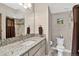Well-lit bathroom with a mosaic tile backsplash, modern fixtures, and a tiled shower with a shower curtain at 31189 Manitoba Dr, Evergreen, CO 80439