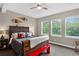 Cozy bedroom with rustic wood bed frame, mountain views from multiple windows, and natural light at 31189 Manitoba Dr, Evergreen, CO 80439