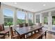 Dining room with natural light, a large wooden table, and scenic views of the surrounding landscape at 31189 Manitoba Dr, Evergreen, CO 80439