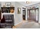 Inviting entryway featuring a carved wood bench, decorative hat rack, and a front door with sidelights at 31189 Manitoba Dr, Evergreen, CO 80439