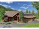 Expansive view of craftsman-style home, showcasing the roof, solar panels, and surrounding landscape at 31189 Manitoba Dr, Evergreen, CO 80439