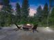 Stone patio area with a fire pit and seating, creating a cozy and inviting outdoor gathering space at 31189 Manitoba Dr, Evergreen, CO 80439