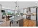 Well-lit kitchen boasts modern appliances, white cabinetry, and a view of the dining area at 31189 Manitoba Dr, Evergreen, CO 80439