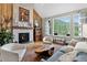 Inviting living room with a stone fireplace, wood accents, and large windows offering scenic views at 31189 Manitoba Dr, Evergreen, CO 80439