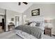 Serene main bedroom featuring a plush bed, soft lighting, and a view of the ensuite bathroom at 31189 Manitoba Dr, Evergreen, CO 80439