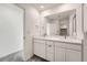 Full bathroom with white cabinets, double sinks, white quartz countertops, a large mirror and chrome fixtures at 1224 S Algonquian St, Aurora, CO 80018
