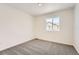 Cozy bedroom with neutral carpet, white walls, a window offering plenty of natural light at 1224 S Algonquian St, Aurora, CO 80018