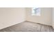 Cozy bedroom with neutral carpet, white walls and a window offering a pleasant view at 1224 S Algonquian St, Aurora, CO 80018