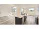 Open floor plan showing kitchen island with modern faucet, quartz countertop, and stainless steel appliances at 1224 S Algonquian St, Aurora, CO 80018