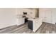 Clean, modern kitchen featuring white cabinets, stainless steel appliances, a kitchen island and quartz countertops at 1224 S Algonquian St, Aurora, CO 80018