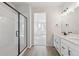 Bright primary bathroom with double vanity, walk-in shower, and modern finishes at 1300 Sienna Peak Cir, Erie, CO 80516