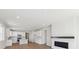 Open-concept living space features modern fireplace and flows into the kitchen at 1300 Sienna Peak Cir, Erie, CO 80516