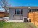 Exterior backyard view with grass, gravel, A/C unit, and wooden fence at 20 S Harrison St, Denver, CO 80209