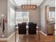 Dining room area bathed in natural light, features an elegant chandelier, and is open to an adjacent kitchen at 20 S Harrison St, Denver, CO 80209