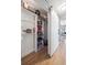 Hallway featuring a barn door, built-in shelving and ample storage, blending style and practicality at 20 S Harrison St, Denver, CO 80209
