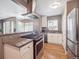 Open kitchen featuring stainless appliances, granite countertops and eat in kitchen at 20 S Harrison St, Denver, CO 80209