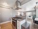 Open kitchen boasts a gas range, breakfast bar, granite countertops, and seamless flow to the living areas at 20 S Harrison St, Denver, CO 80209